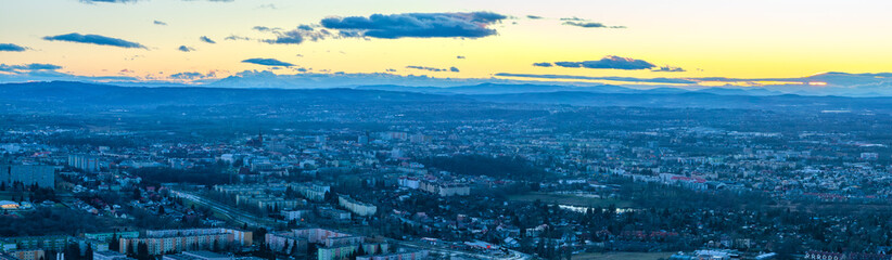 Tarnów panorama at dawn  Cityscape of Tarnów, Poland, bathed in the soft glow of dawn with the majestic Tatra Mountains gracing the horizon
