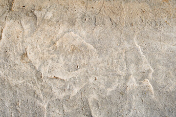 Cracked concrete wall covered with gray cement surface. Grey old wall with shabby damaged plaster or cement and brick background of an vintage dirty exfoliating plaster. Mock up.