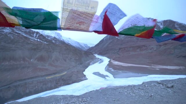 buddhist prayer flag waving in front of  Himalayas mountains. 