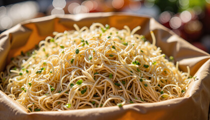 Delicious noodles served in a paper bag at a vibrant market stall, culinary delight