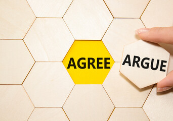 Agree or Argue symbol. Concept word Agree or Argue on wooden puzzle. Businessman hand. Beautiful...