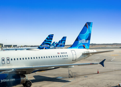 JFK airport, New York, USA - November, 18, 2024: 6 Jetblue aircraft parked at  JFK airport gates