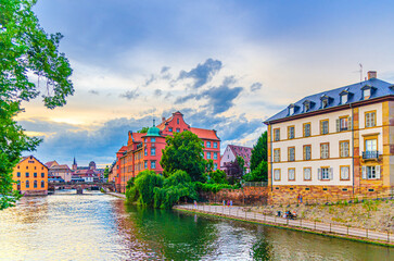 Obraz premium Strasbourg city historic centre with quay embankment promenade River Ill canal, Public Primary School Saint-Thomas Palais de la Monnaie in old town Grande ile Grand Island, Alsace region, France