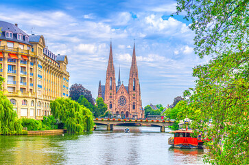 St. Paul's Church Eglise reformee Saint-Paul Gothic Revival style building and Pont Royal bridge across River Ill canal in old town Strasbourg city historic centre, Alsace Grand Est region, France