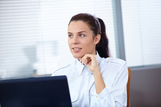 Young businesswoman sitting at workplace