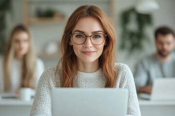portrait of writer working on laptop in minimalist home office surrounded by soft natural light