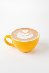 A yellow cup of cappuccino, latte, flat white coffee with latte art