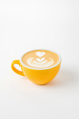 A yellow cup of cappuccino, latte, flat white coffee with latte art