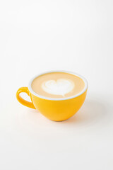 A yellow cup of cappuccino, latte, flat white coffee with latte art
