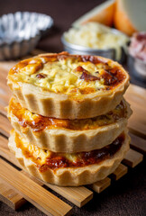 Quiche Lorraine. A traditional French dish. It is a traditional recipe from Lorraine, a region in northeastern France. It is a savory cheese pie topped with a mixture of cream and eggs, bacon, 