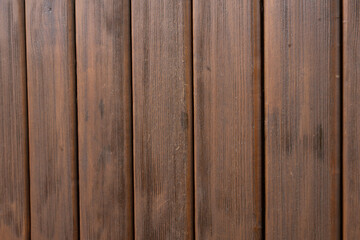 Vertical wooden panels with dark rough texture