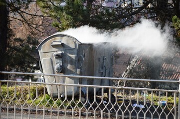 smoke from a burning container on the street