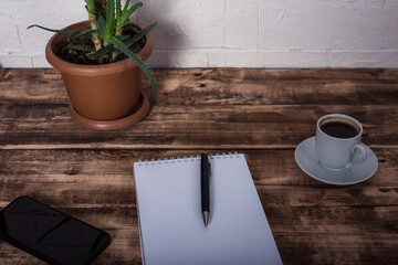 Open notebook with pen and coffee in studio