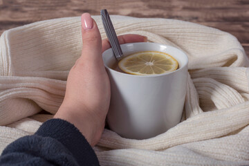 Woman hands  holding a cup of hot tea