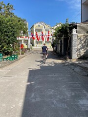 Cycling around the street of Hoi An through rice fields in Vietnam, travel UGC bike riding, vacation, holiday. 