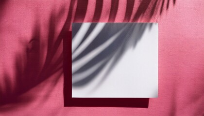 natural light casts shadows from the palm tree one square sheets of white textured paper lying on an pink textured background mockup