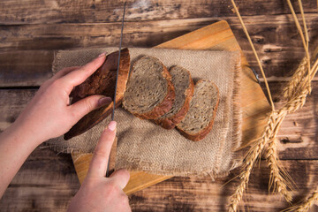 Woman Slicing Mixed Grain Bread