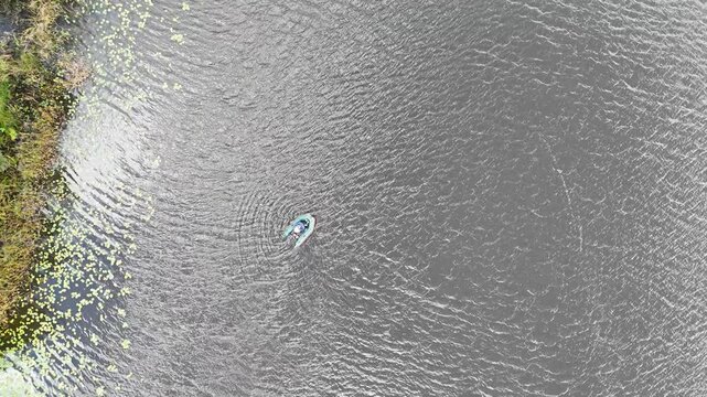 Aerial View of Boat on Lake with Water Lilies