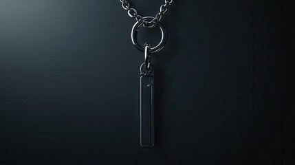 Sleek black metal necklace with minimalistic rectangular pendant on dark background