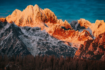 Last sunset light at the top of the winter mountains. Rocky Mountain Ridge in the evening