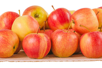 Red and yellow apples on a napkin isolated on white.