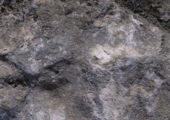 Texture of ancient rock formation showcasing layers in sunlight at midday