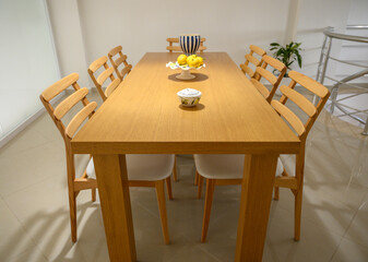 Elegant wooden dining table set for a cozy gathering in a modern home during a bright afternoon