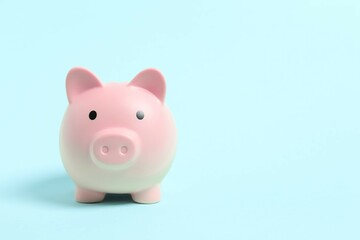 Piggy coin bank on color background for money savings, financial security or personal funds concept