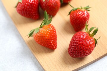 Delicious fresh red strawberries on a wooden background