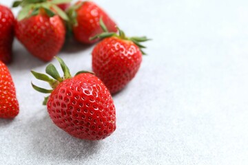 Delicious fresh red strawberries on a gray background