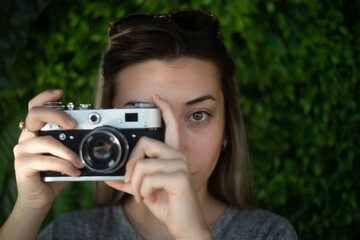 Woman taking a photo with a retro camera