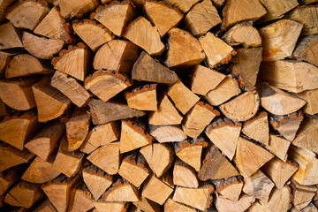Oak firewood for heating a room close-up. Stacked cut and chopped firewood in winter