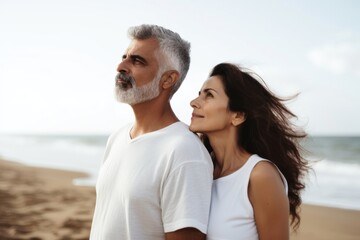 Latina brazillian middle age Loving couple standing at beach shore while looking away summer adult contemplation.