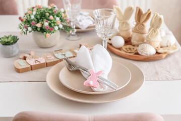 Festive Easter table setting with Easter bunny made from napkin. Easter celebration concept
