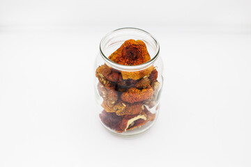 Dried amanita mushrooms in a glass jar.