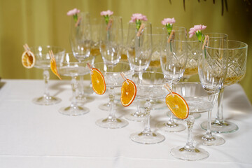 Elegant dessert table featuring decorated glassware with garnishes at a festive gathering
