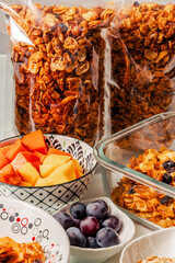Healthy breakfast ingredients with handmade granola and fruits mango, papaya and grapes