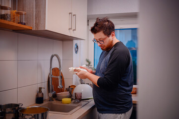 Man Cooking and Cleaning in Cozy Kitchen