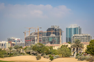 High-Rise Residential Buildings Under Construction with Tower Cranes  
