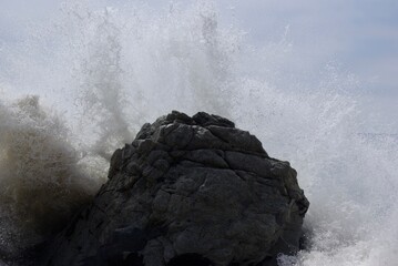 Powerful waves crashing into rock