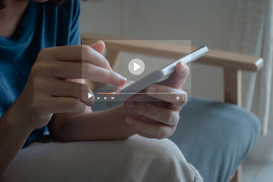 Woman touching smartphone to watching and live streaming window for Video streaming on internet and multimedia technology, live video content online streaming marketing concept.