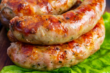 Juicy grilled sausages served on fresh lettuce
