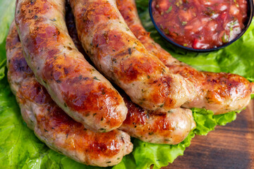 Savory sausages served with fresh salsa on a bed of lettuce