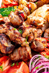 Grilled meat platter with fresh vegetables and herbs