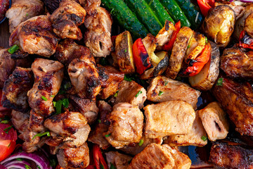 Grilled meats and vegetables served on a wooden platter