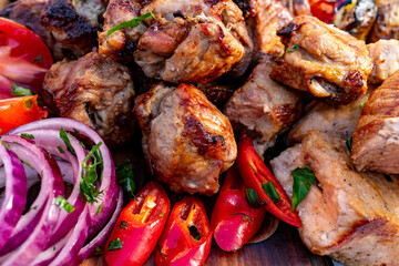 Grilled meat and fresh vegetables served at outdoor feast