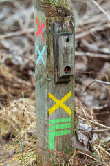 Itineraries in France, repere excursion marking. Hiking trail marking in France on a wooden pole.