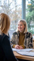 A social worker listens attentively to a client, providing guidance in a bright and welcoming office. The atmosphere is warm, fostering open communication