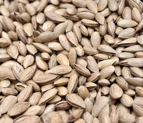 Roasted delicious inshell almonds with spices in large quantities for sale at the vegetable market. Close-up