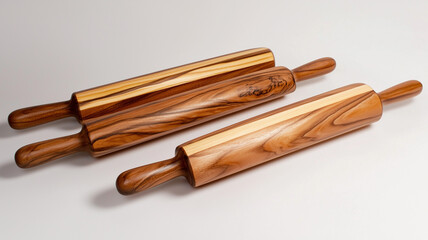Set of wooden rolling pins with natural grain texture on neutral background

